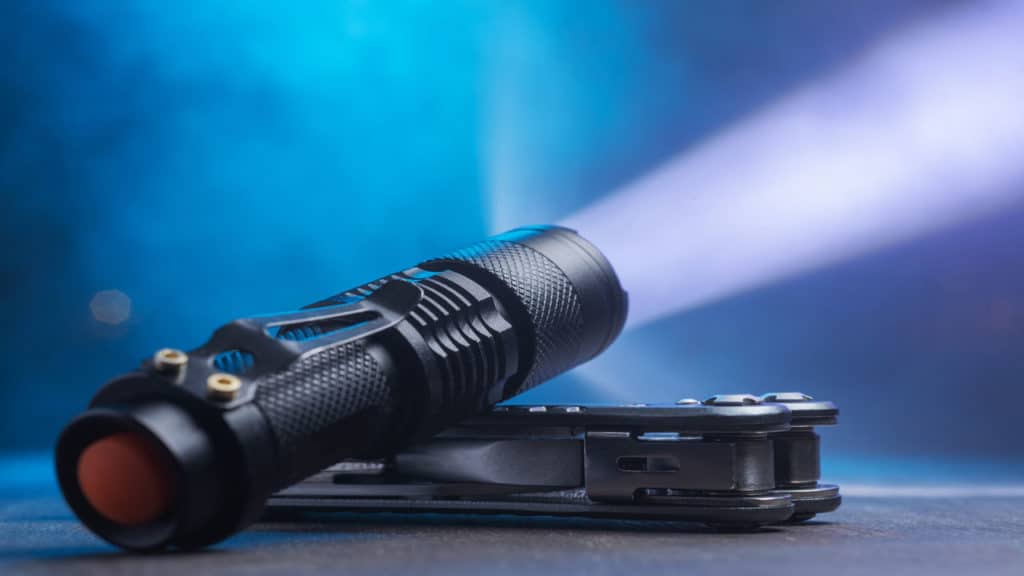 A tactical flashlight iluminating its surroundings